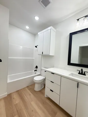 a bathroom with a sink a toilet and bathtub