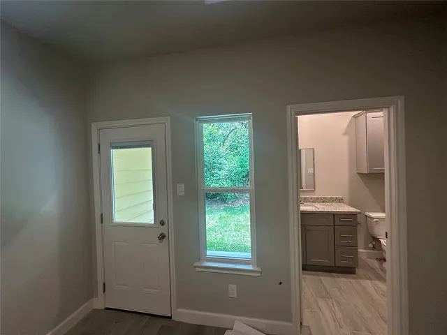 an empty room with windows and closet