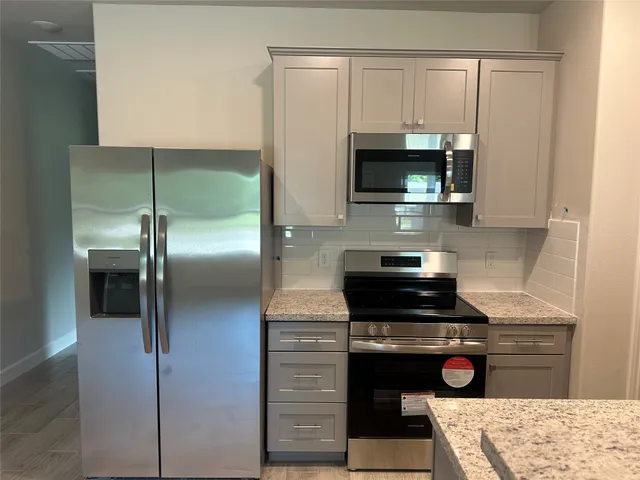 a kitchen with a stove and a microwave