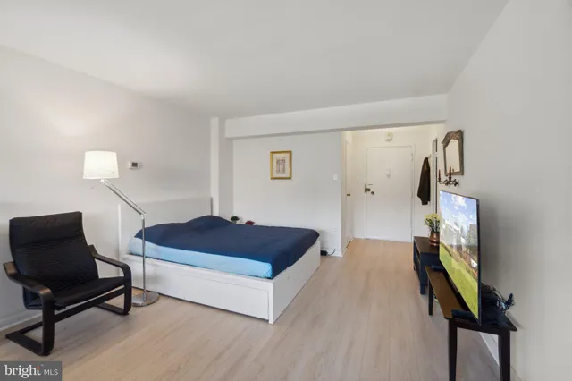 a living room with furniture and a lamp