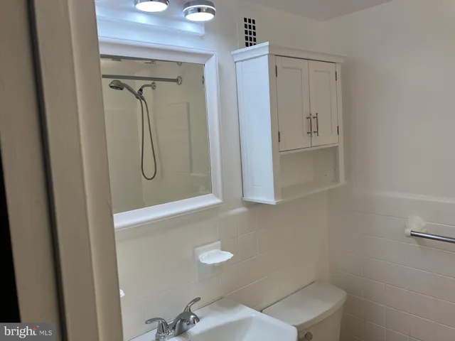 a bathroom with a shower a toilet and sink