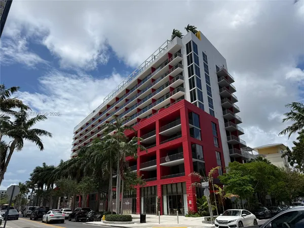 a view of a tall building next to a road