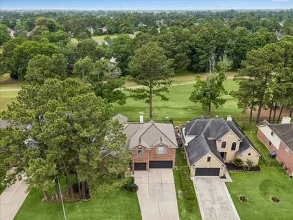 an aerial view of a house with a yard