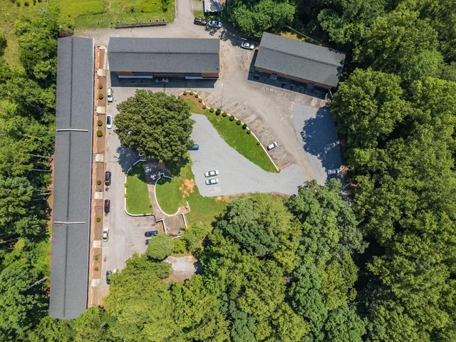 an aerial view of a house with a yard and garden