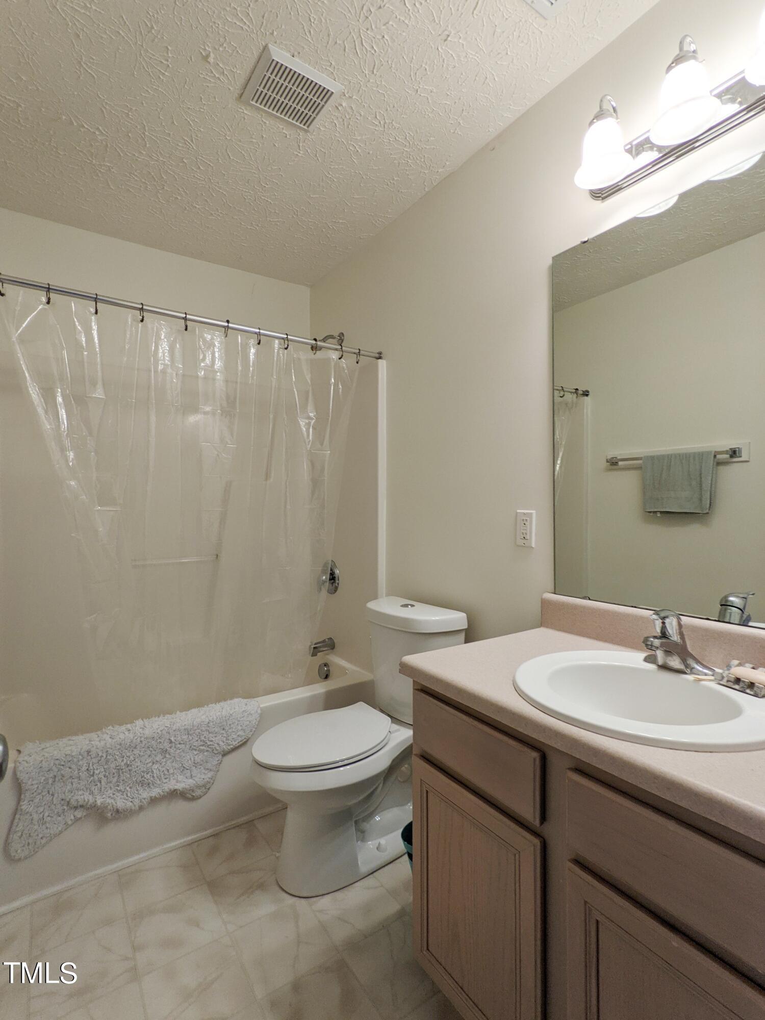 424 St John Drive Durham, NC 27703 - Photo 13 of 14 a bathroom with a sink toilet and shower