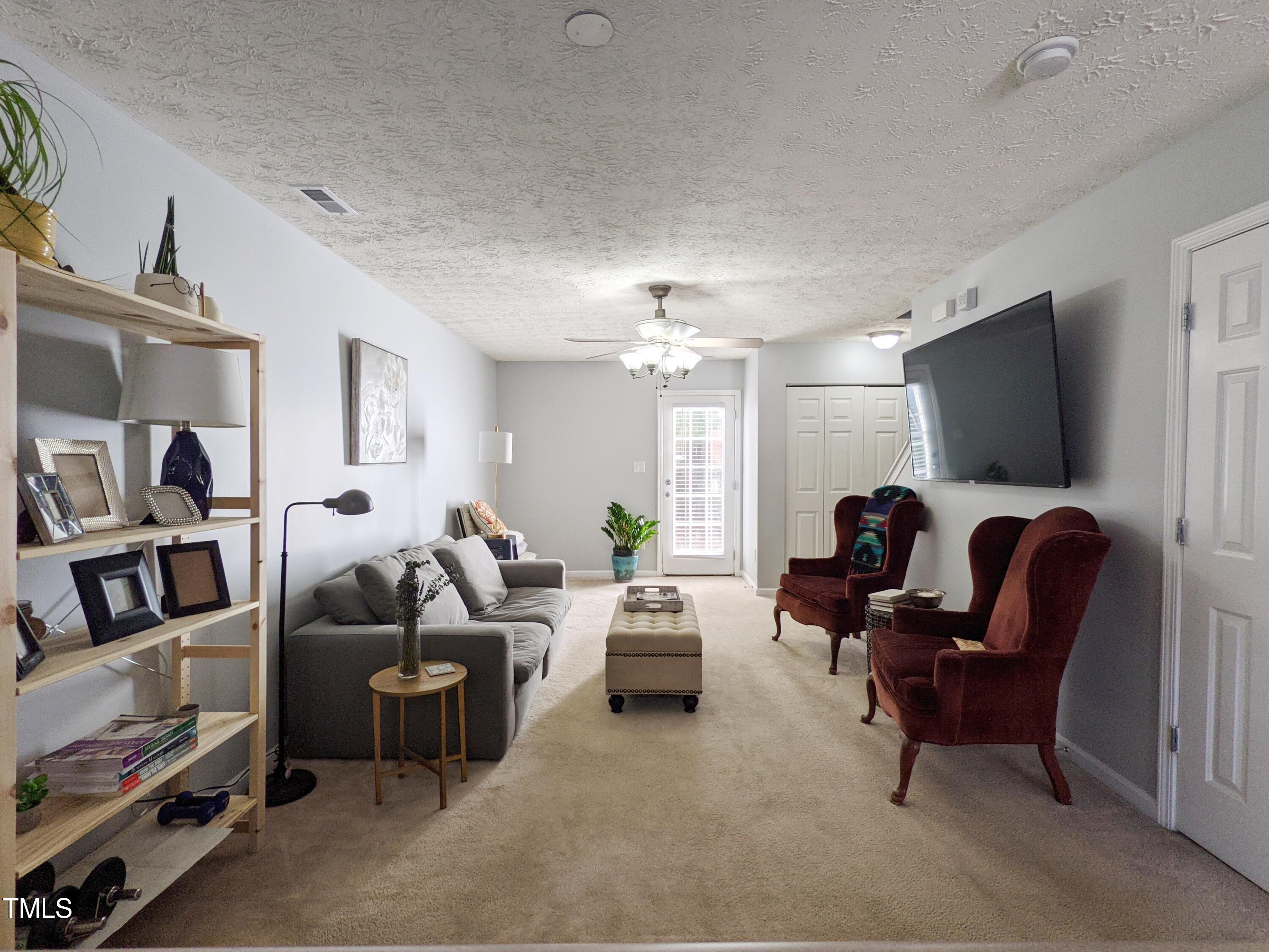 424 St John Drive Durham, NC 27703 - Photo 3 of 14 a living room with furniture and a flat screen tv