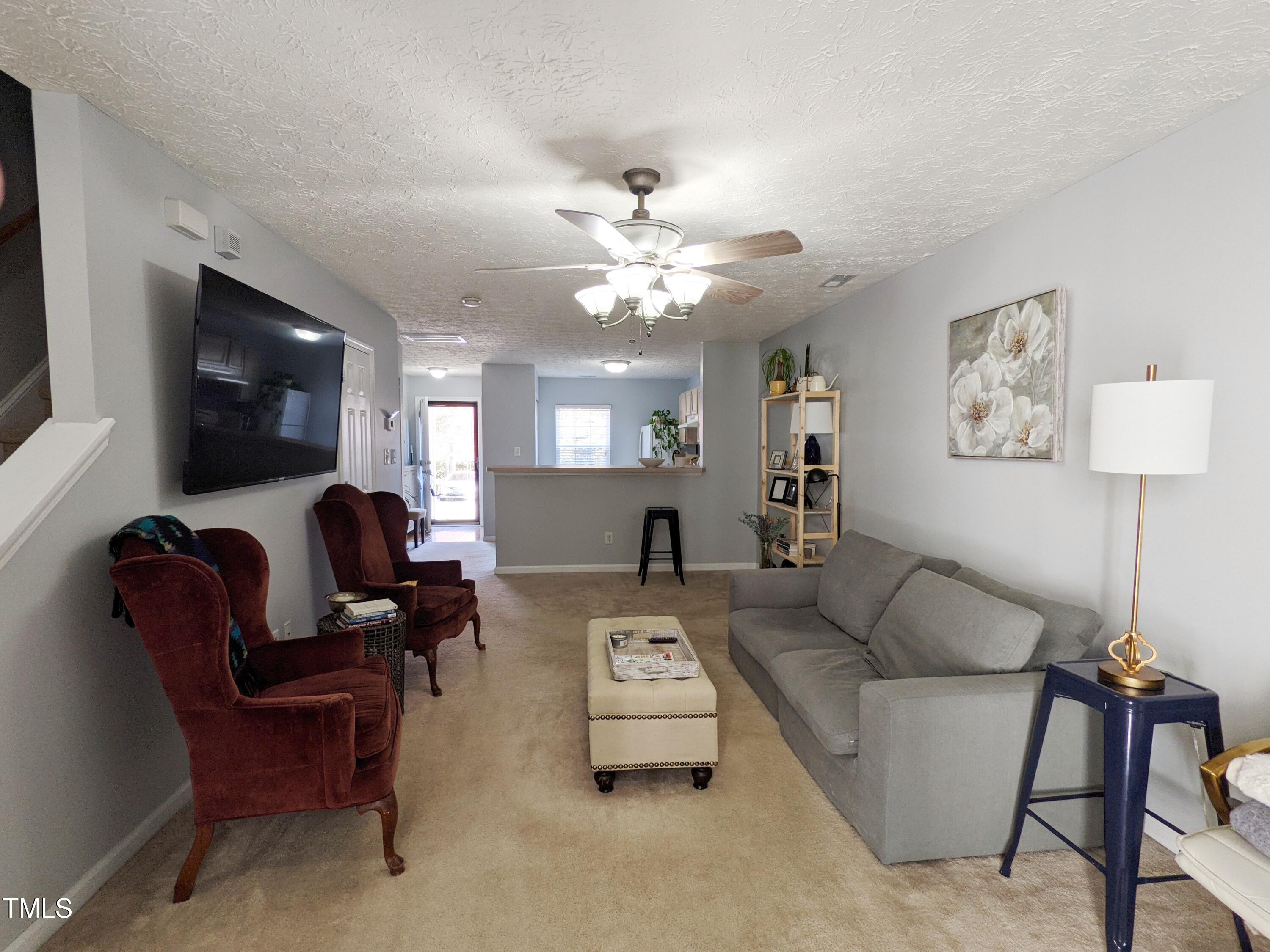 424 St John Drive Durham, NC 27703 - Photo 4 of 14 a living room with furniture and a flat screen tv