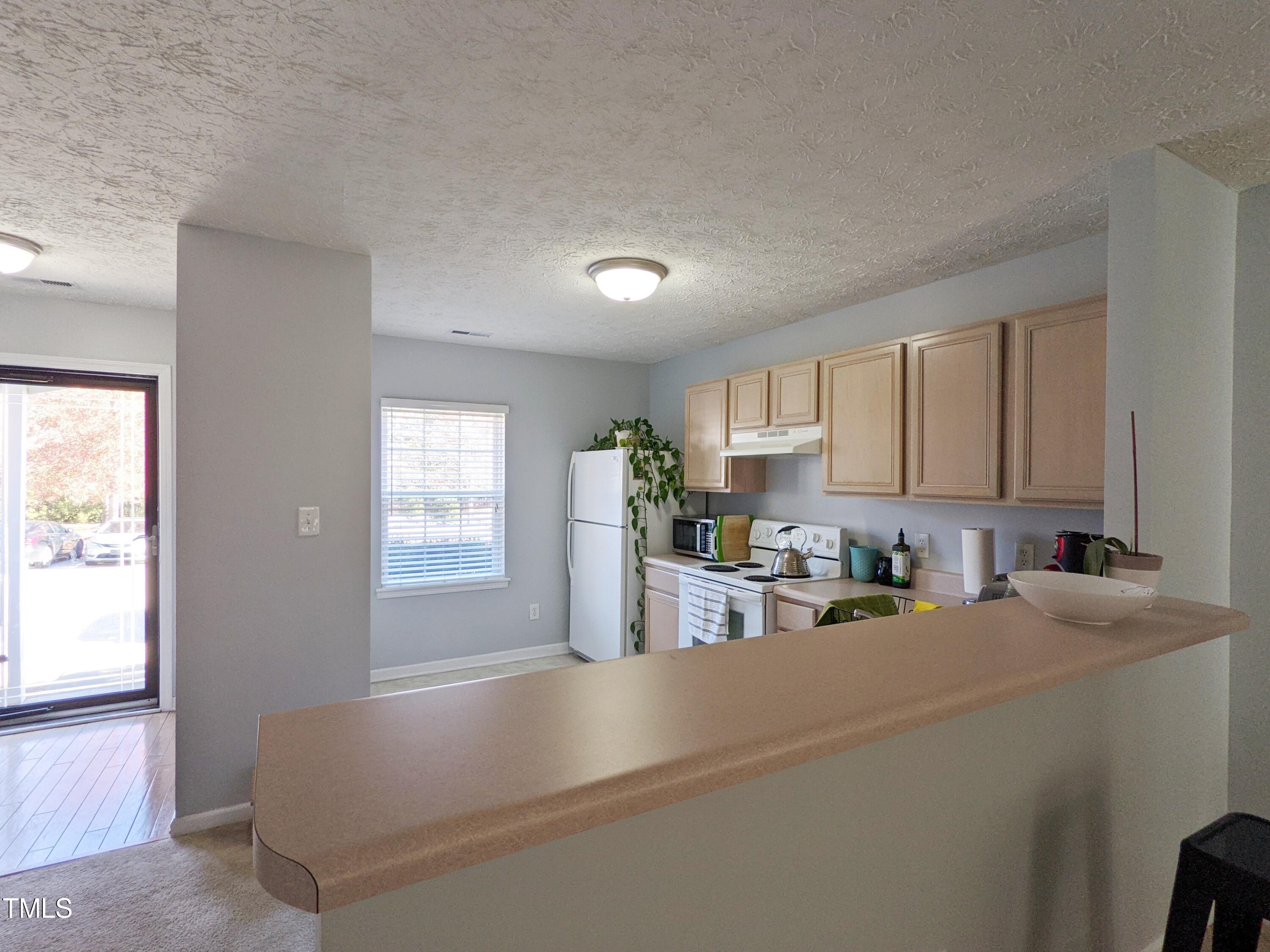 424 St John Drive Durham, NC 27703 - Photo 6 of 14 a kitchen with a sink cabinets and window