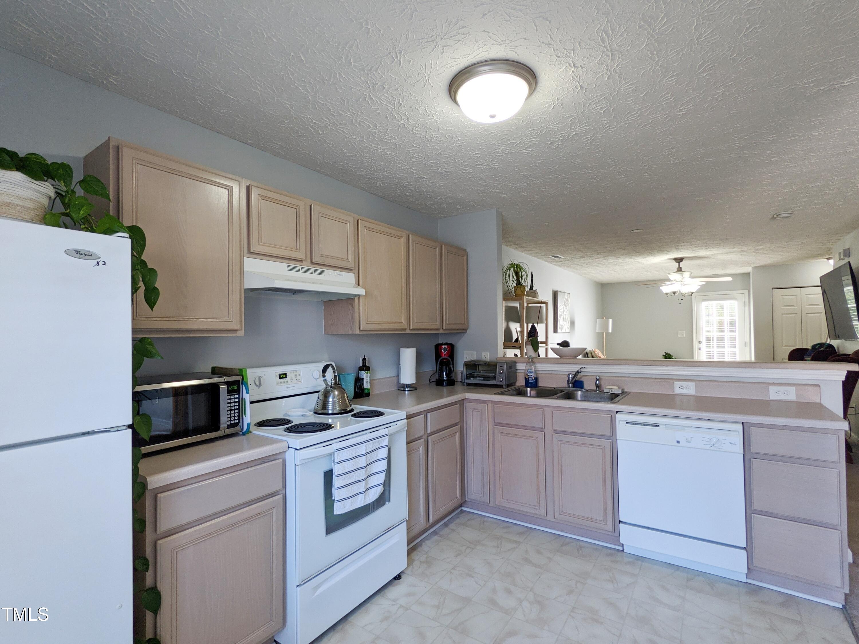 424 St John Drive Durham, NC 27703 - Photo 7 of 14 a kitchen with a sink stove and cabinets