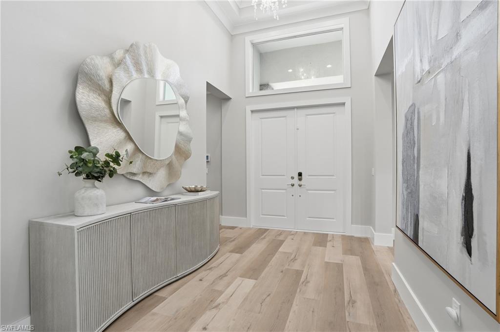 12021 Azalea Way Naples, FL 34120 - Photo 7 of 50 Step inside the beautifully appointed foyer with soaring 14 foot ceilings and stunning chandelier.