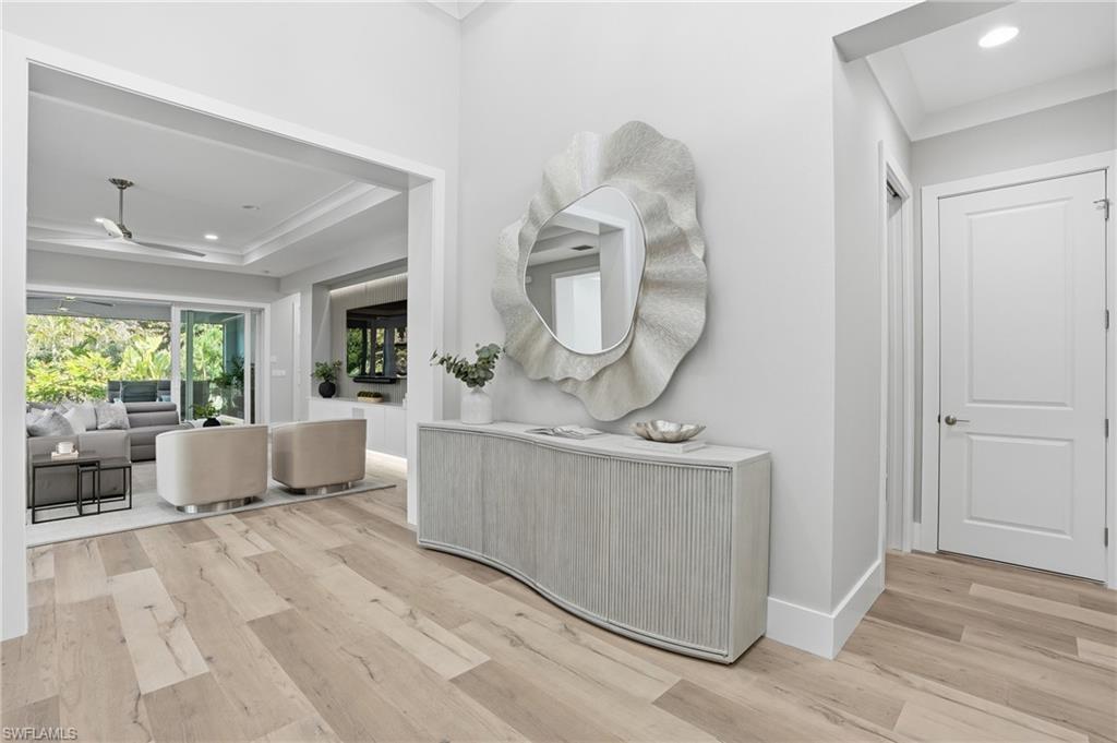 12021 Azalea Way Naples, FL 34120 - Photo 8 of 50 Right away, notice the tasteful decor and stunning wide plank hardwood floors.