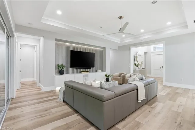 a bedroom with a large bed and a flat tv screen on dresser