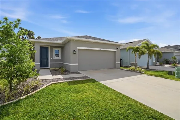 a front view of a house with a yard and garage
