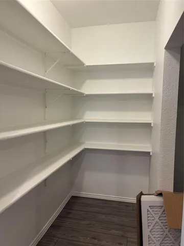 a kitchen with sink a microwave and cabinets