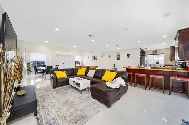 a living room with furniture kitchen view and a table