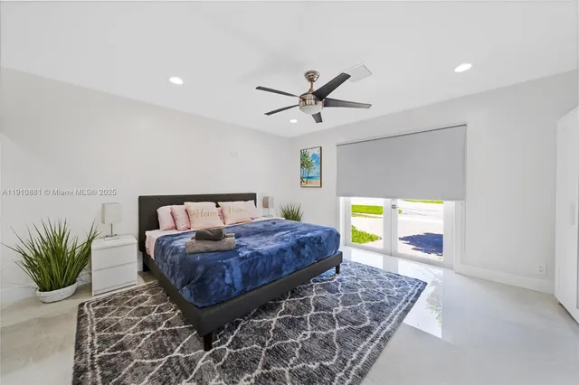 a bedroom with a bed and ceiling fan