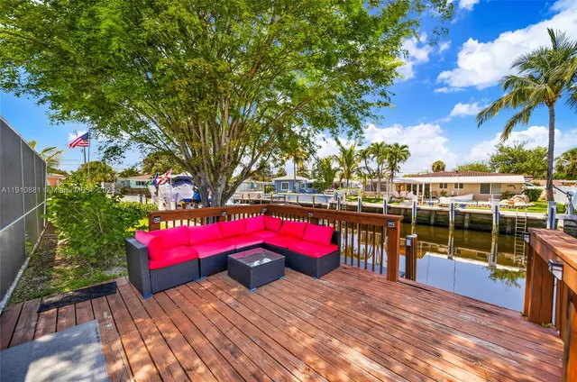 a view of a house with a yard and furniture