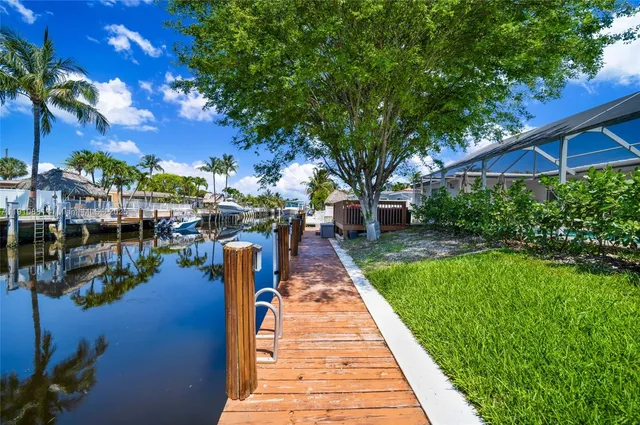 a front view of a house with a garden and trees