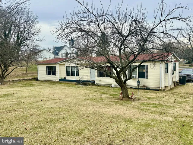 a house that has a tree in front of it