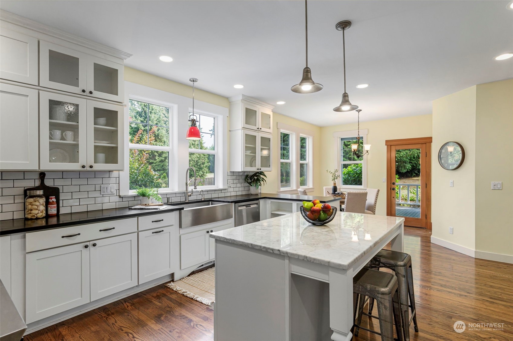 6457 Haley Loop Road Northeast Bainbridge Island, WA 98110 - Photo 12 of 40 a kitchen with a sink a counter space dining table and chairs