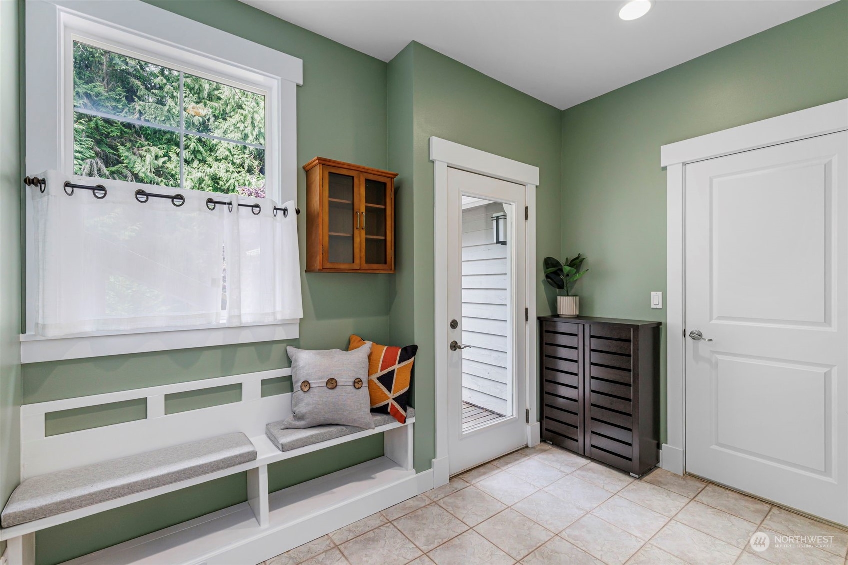6457 Haley Loop Road Northeast Bainbridge Island, WA 98110 - Photo 17 of 40 a bedroom with a bed and a window