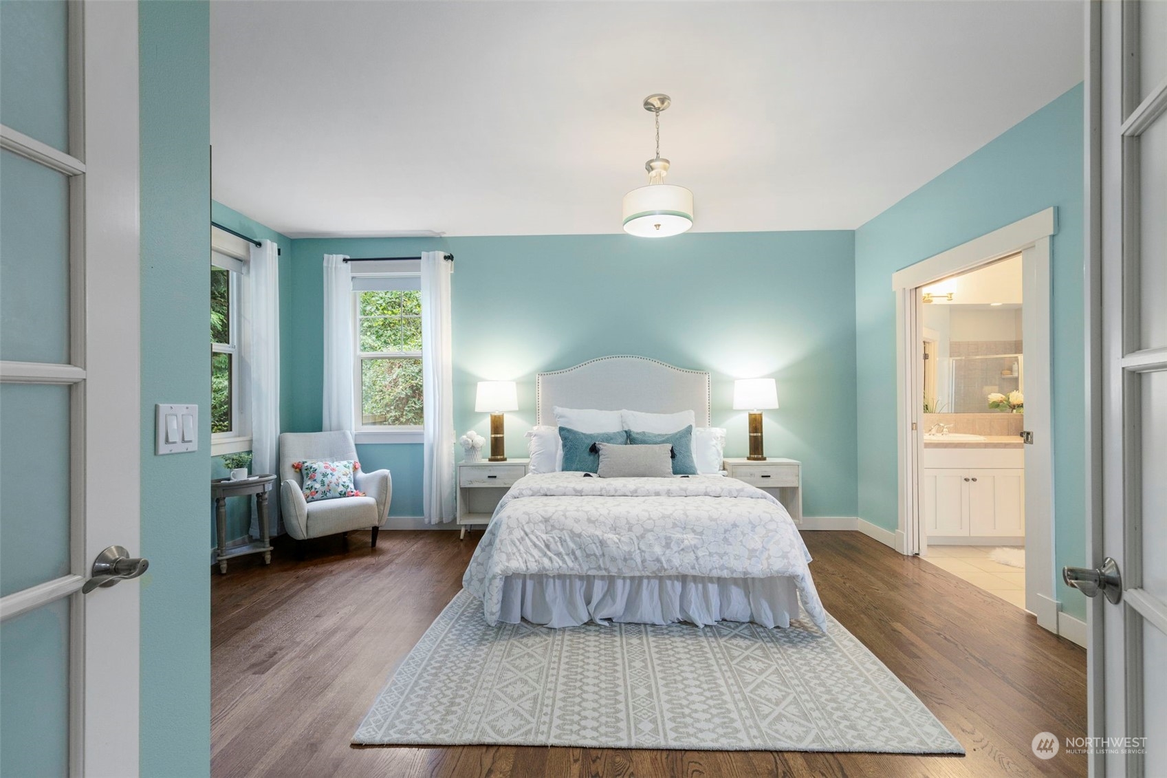 6457 Haley Loop Road Northeast Bainbridge Island, WA 98110 - Photo 19 of 40 a bedroom with a bed and wooden floor