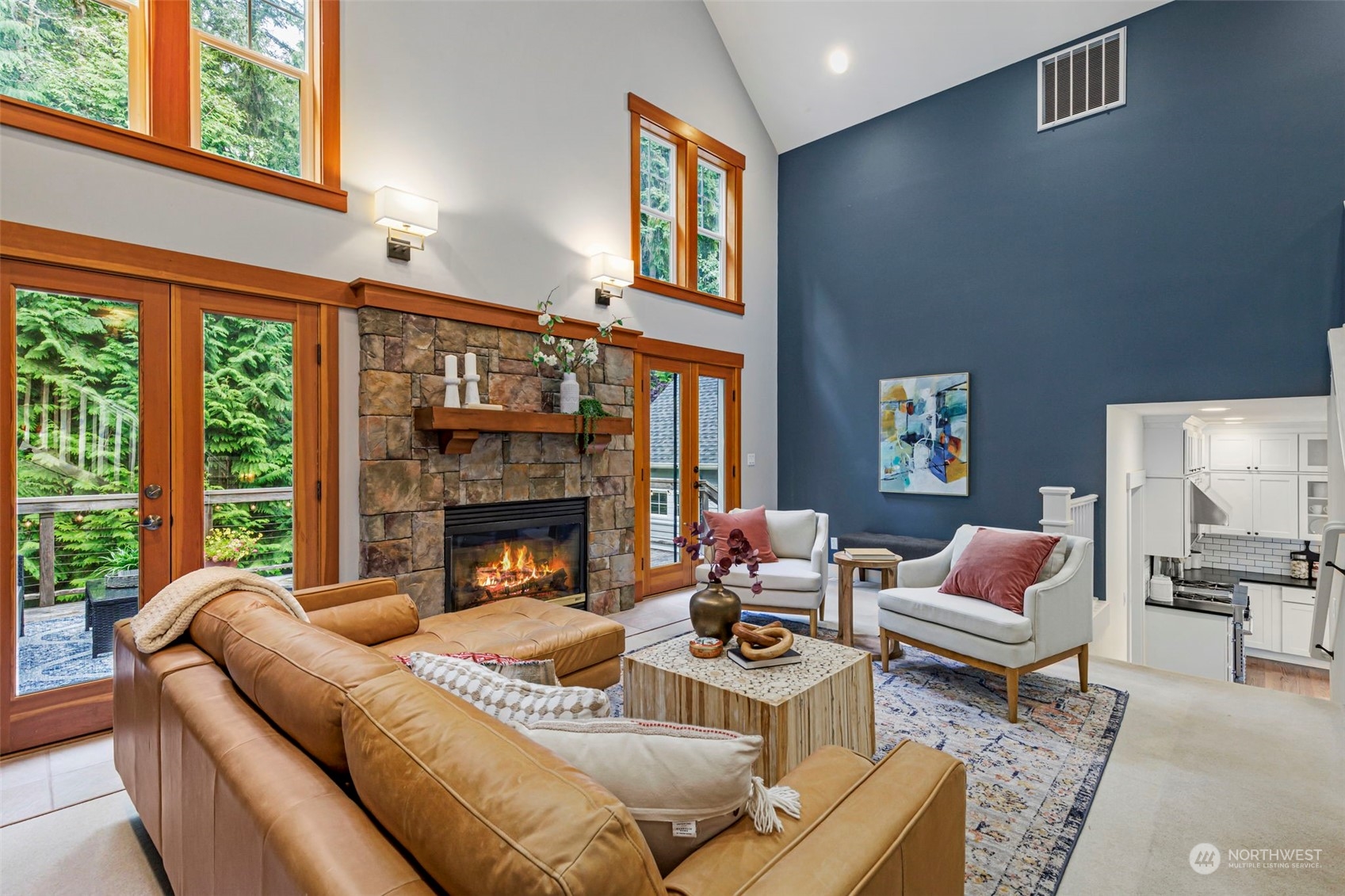 6457 Haley Loop Road Northeast Bainbridge Island, WA 98110 - Photo 9 of 40 a living room with furniture fireplace and a large window