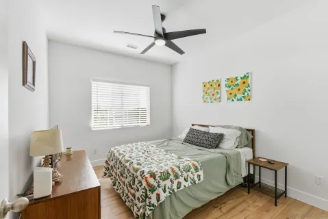 a bedroom with a bed and a window