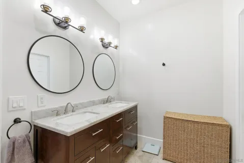 a bathroom with a double vanity sink and a mirror
