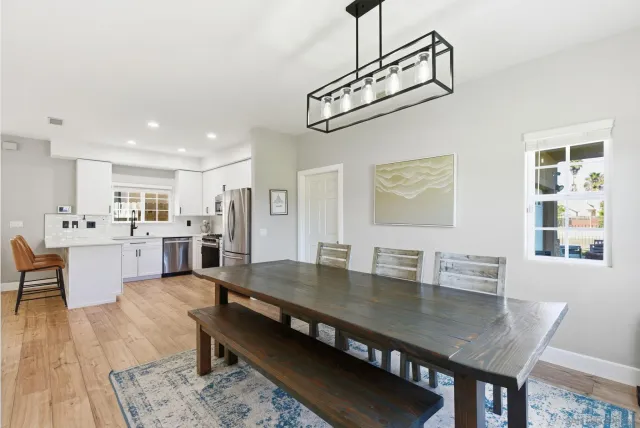 a view of a dining room with furniture and wooden floor
