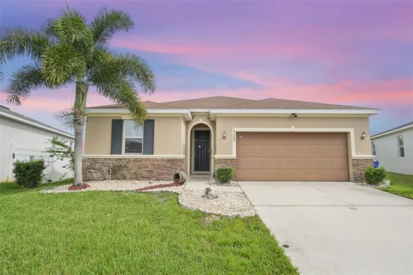 a front view of a house with a yard and garage
