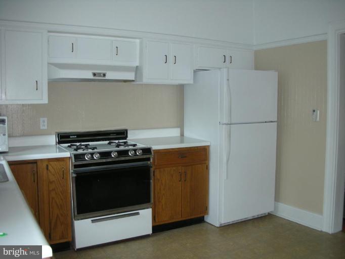 635 Deepdene Road Baltimore, MD 21210 - Photo 7 of 11 a kitchen with a stove and a refrigerator