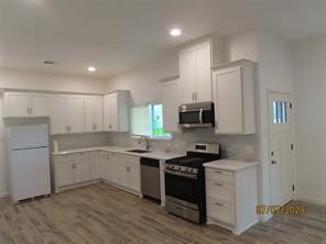 403 High Ridge Street Houston, TX 77013 - Photo 8 of 13 a kitchen with a sink stove and cabinets