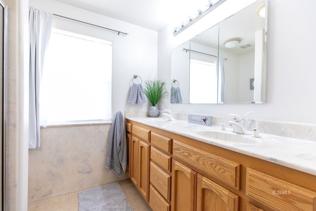6542 Ridgecrest Boulevard Inyokern, CA 93527 - Photo 34 of 50 a bathroom with a double vanity sink and a mirror