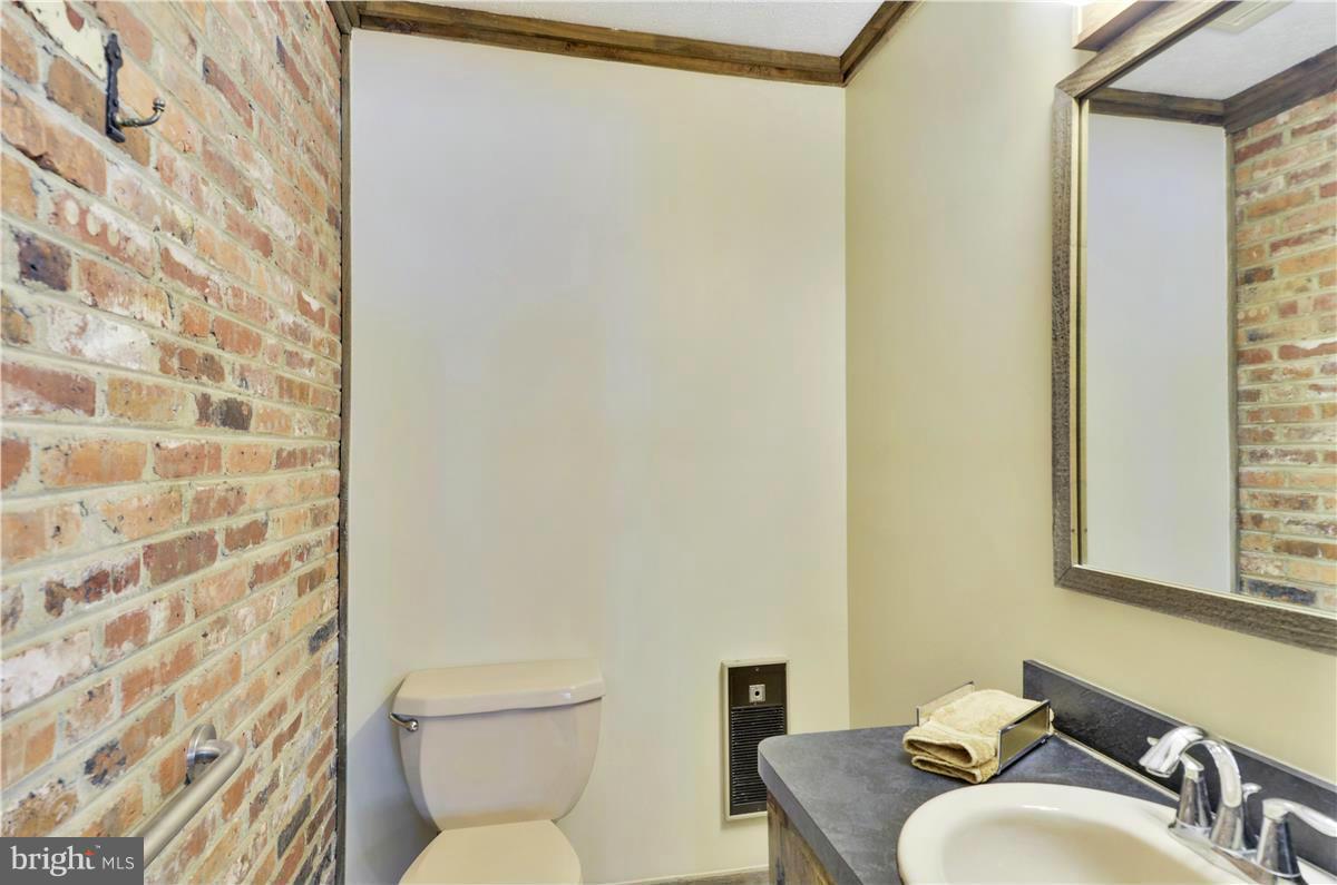 2117 Apple Tree Lane Silver Spring, MD 20905 - Photo 16 of 30 a bathroom with a toilet and a sink