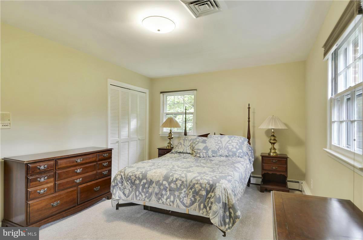 2117 Apple Tree Lane Silver Spring, MD 20905 - Photo 20 of 30 a bedroom with a bed and wooden floor