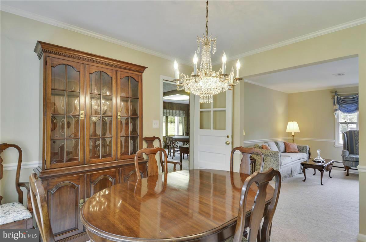 2117 Apple Tree Lane Silver Spring, MD 20905 - Photo 7 of 30 a dining room with furniture a chandelier and wooden floor
