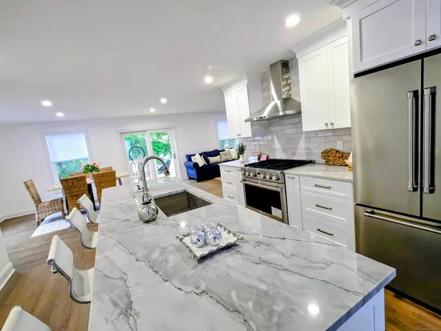 a kitchen with a sink appliances and cabinets