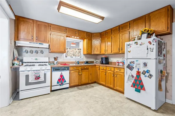 a view of kitchen with refrigerator and microwave