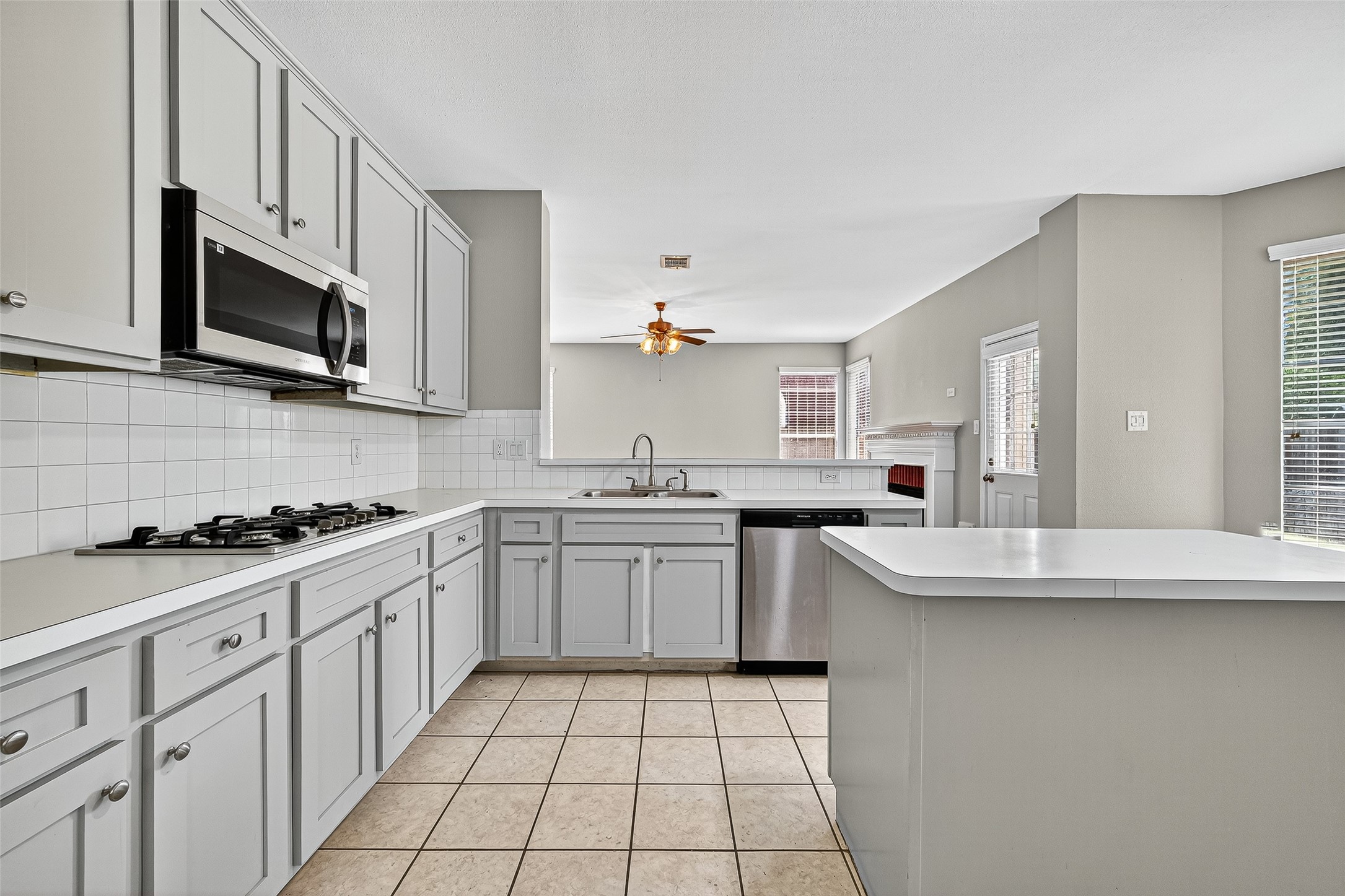 7411 Pacific Ridge Court Houston, TX 77095 - Photo 11 of 50 a kitchen with stainless steel appliances granite countertop a sink and stove top oven