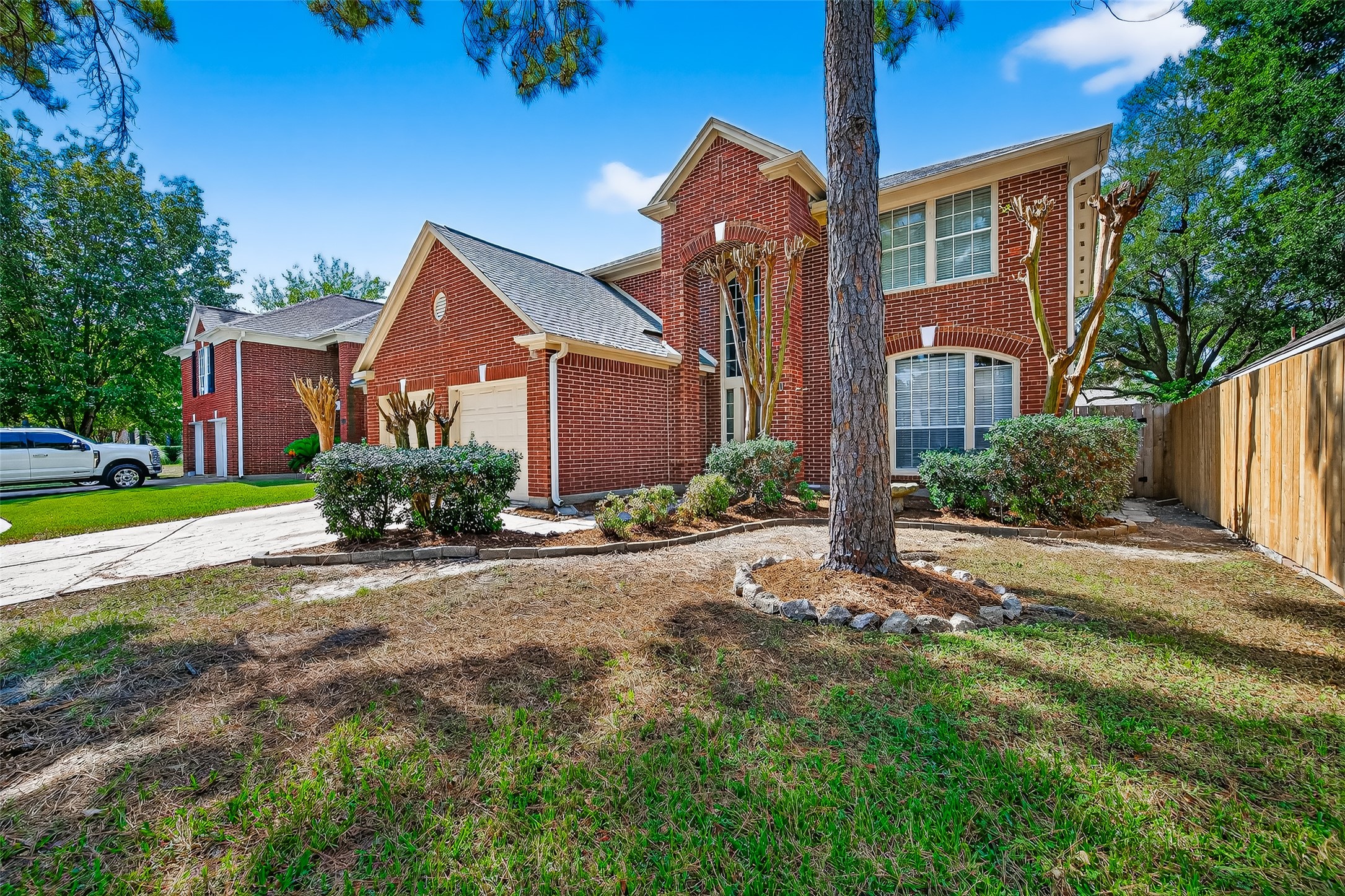 7411 Pacific Ridge Court Houston, TX 77095 - Photo 2 of 50 a front view of a house with a yard and outdoor seating