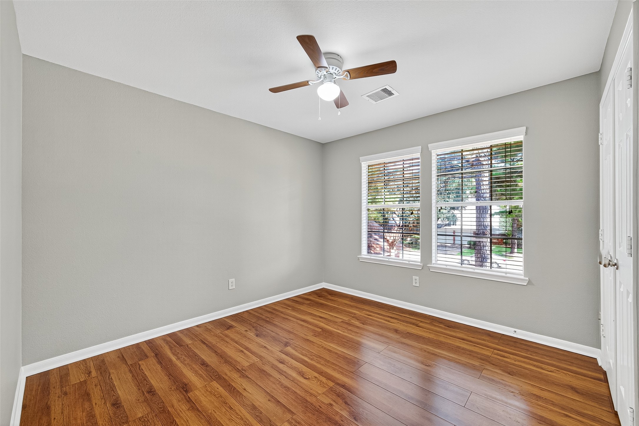 7411 Pacific Ridge Court Houston, TX 77095 - Photo 25 of 50 a view of an empty room with wooden floor and a window