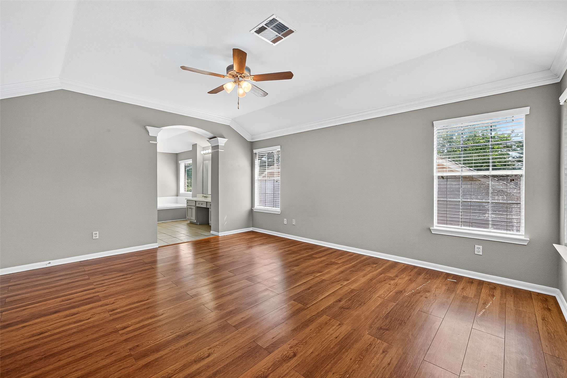 7411 Pacific Ridge Court Houston, TX 77095 - Photo 28 of 50 an empty room with wooden floor chandelier fan and windows