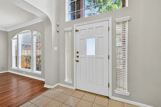 a view of entryway with wooden floor and front door