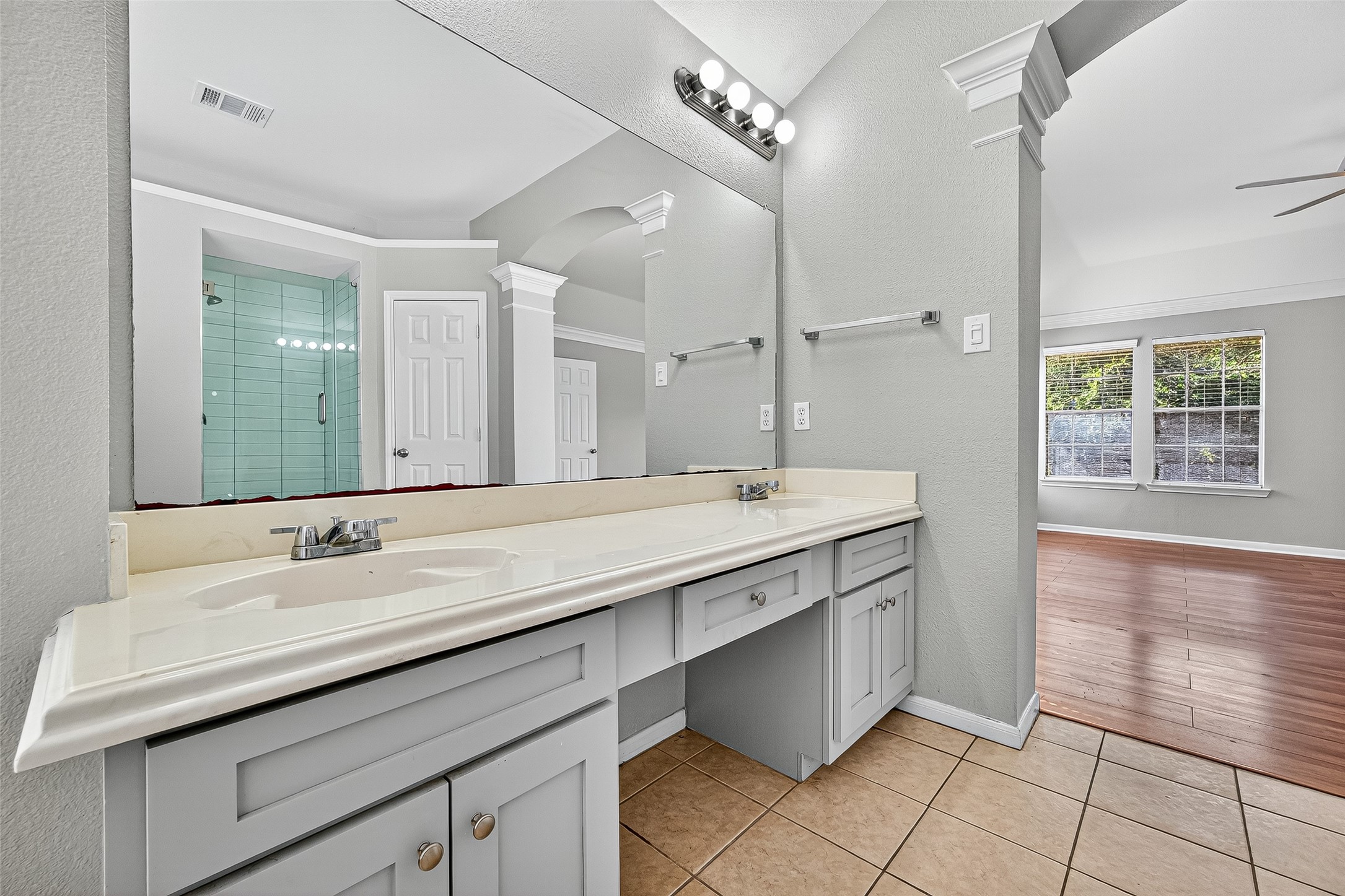 7411 Pacific Ridge Court Houston, TX 77095 - Photo 31 of 50 a bathroom with a double vanity sink a mirror and a shower