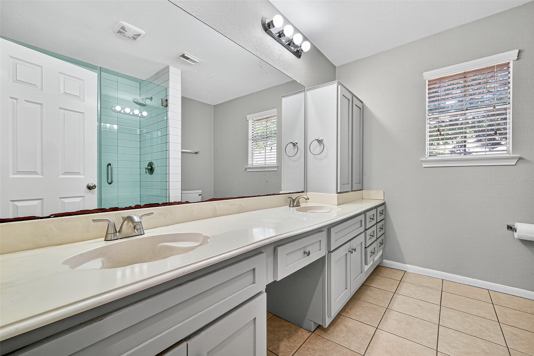 7411 Pacific Ridge Court Houston, TX 77095 - Photo 42 of 50 a bathroom with a sink double vanity and a mirror