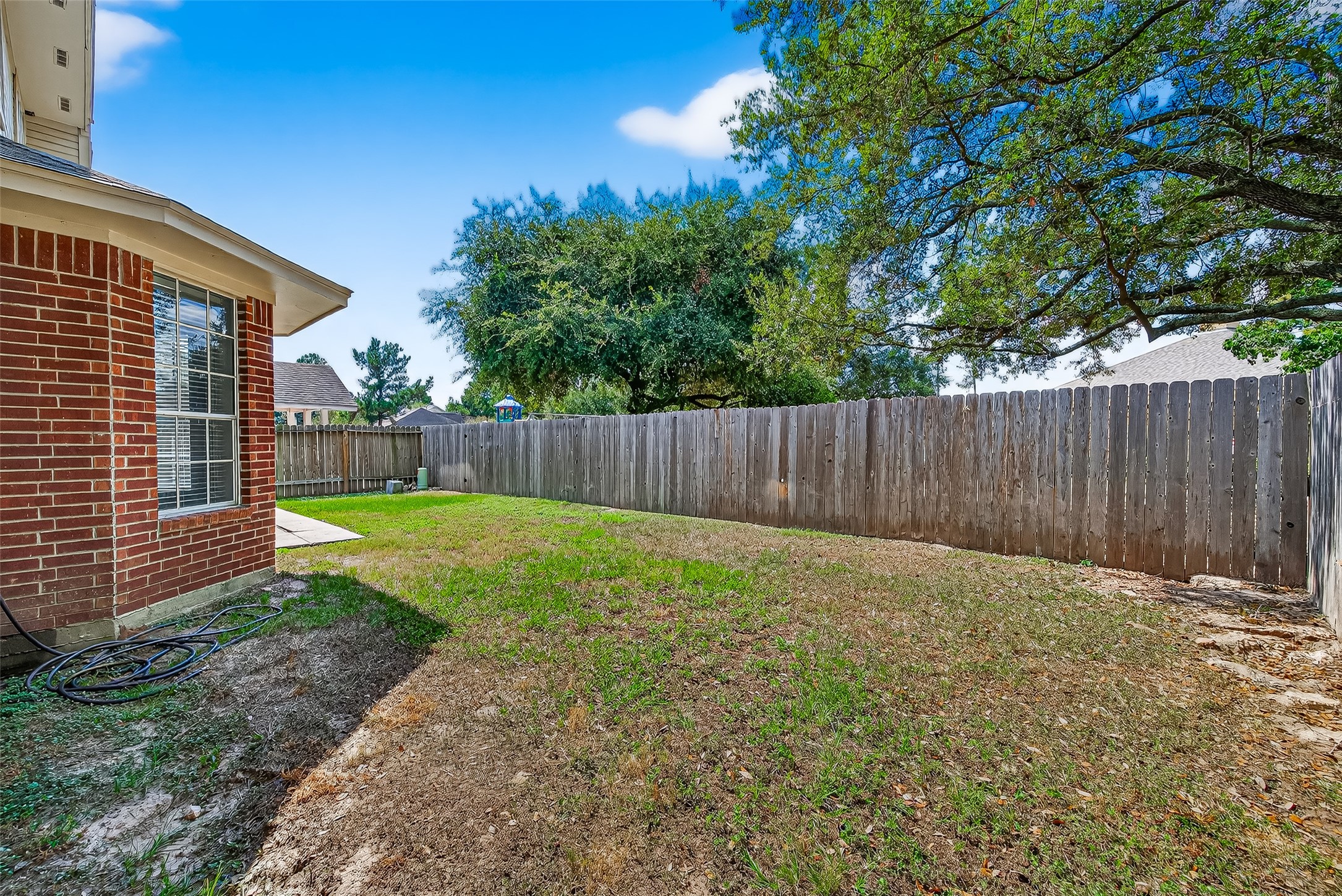 7411 Pacific Ridge Court Houston, TX 77095 - Photo 44 of 50 a view of a backyard with wooden fence