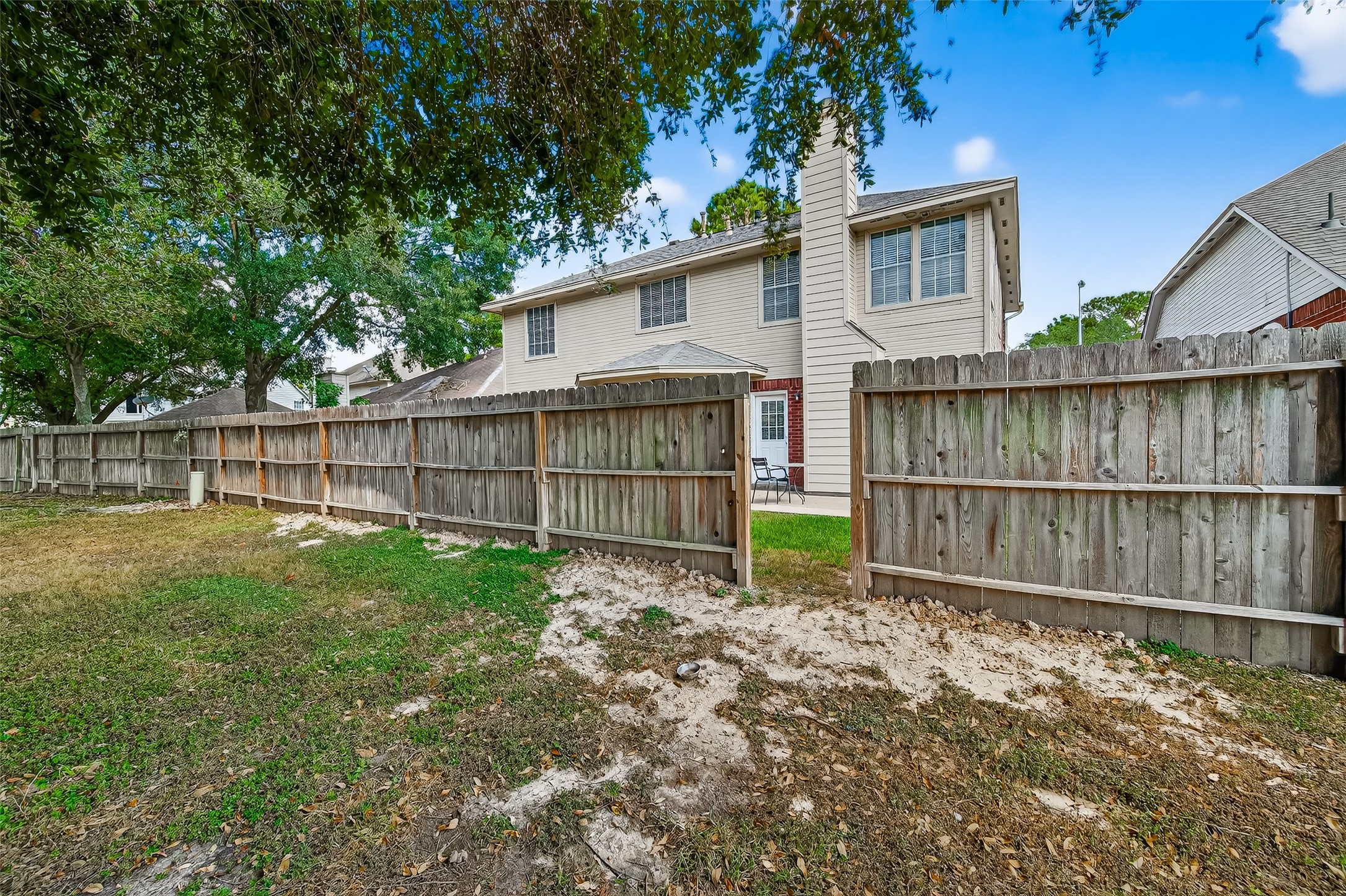 7411 Pacific Ridge Court Houston, TX 77095 - Photo 48 of 50 a view of a backyard with a large tree and wooden fence