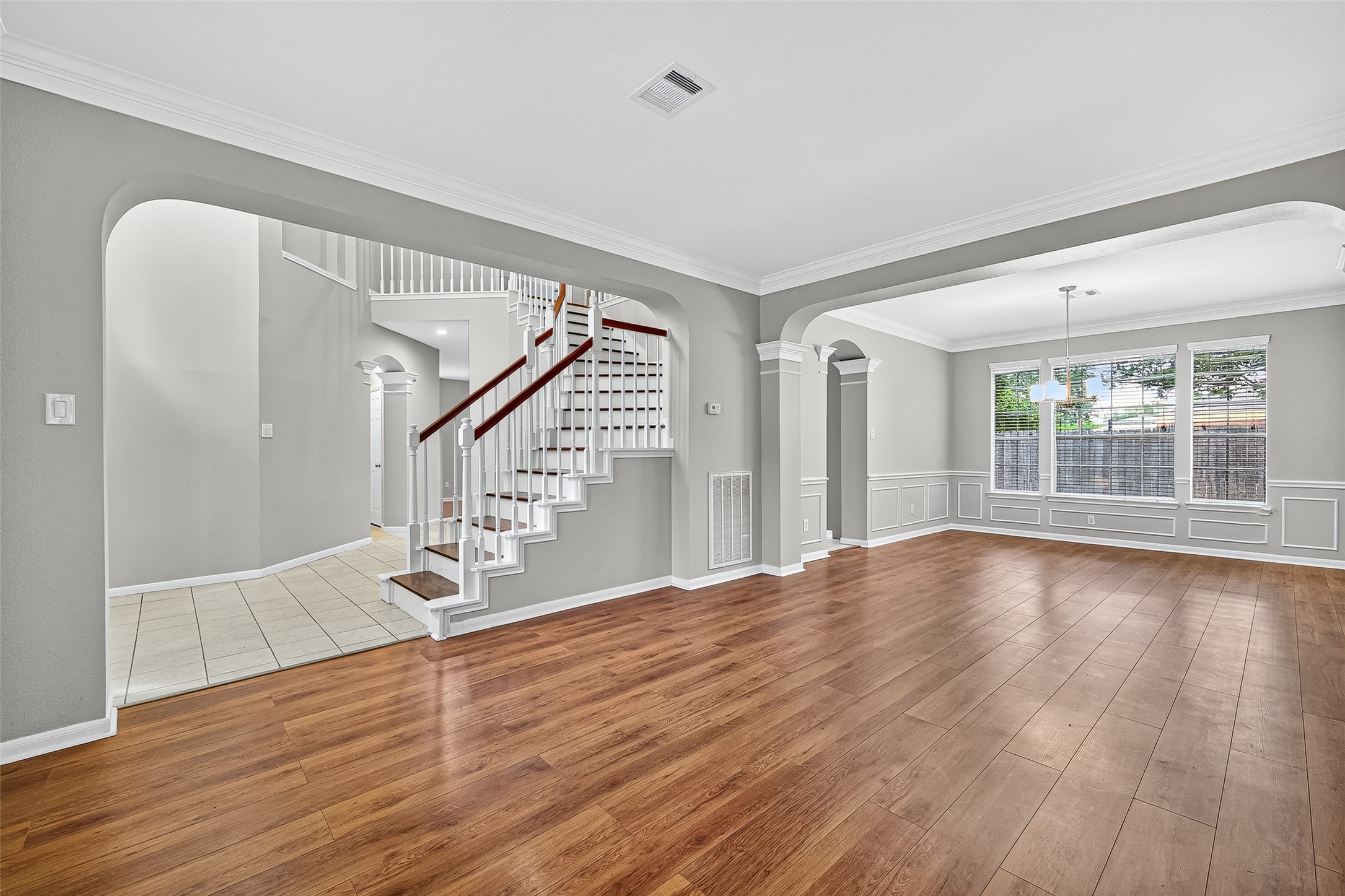 7411 Pacific Ridge Court Houston, TX 77095 - Photo 5 of 50 a view of an empty room with wooden floor and staircase