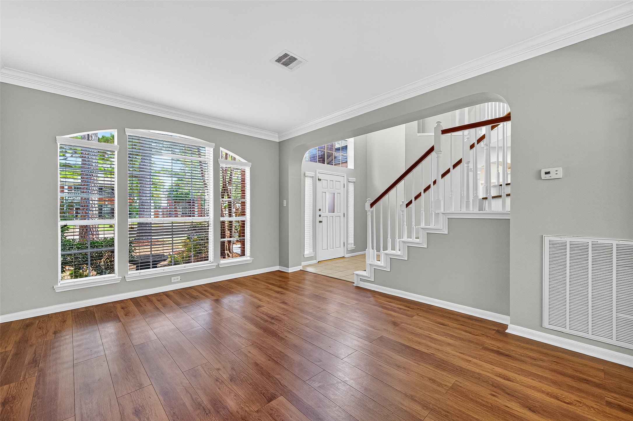 7411 Pacific Ridge Court Houston, TX 77095 - Photo 6 of 50 a view of an empty room with wooden floor and a window